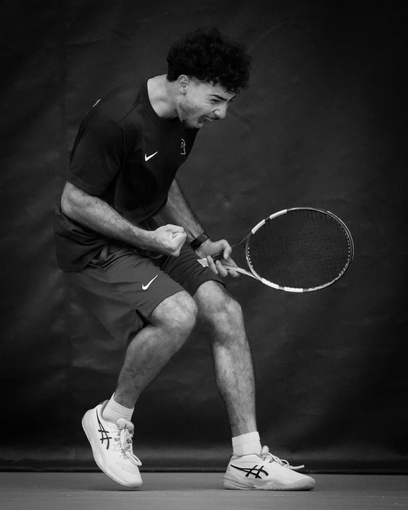 Tennis player celebrating with a clenched fist, in black and white